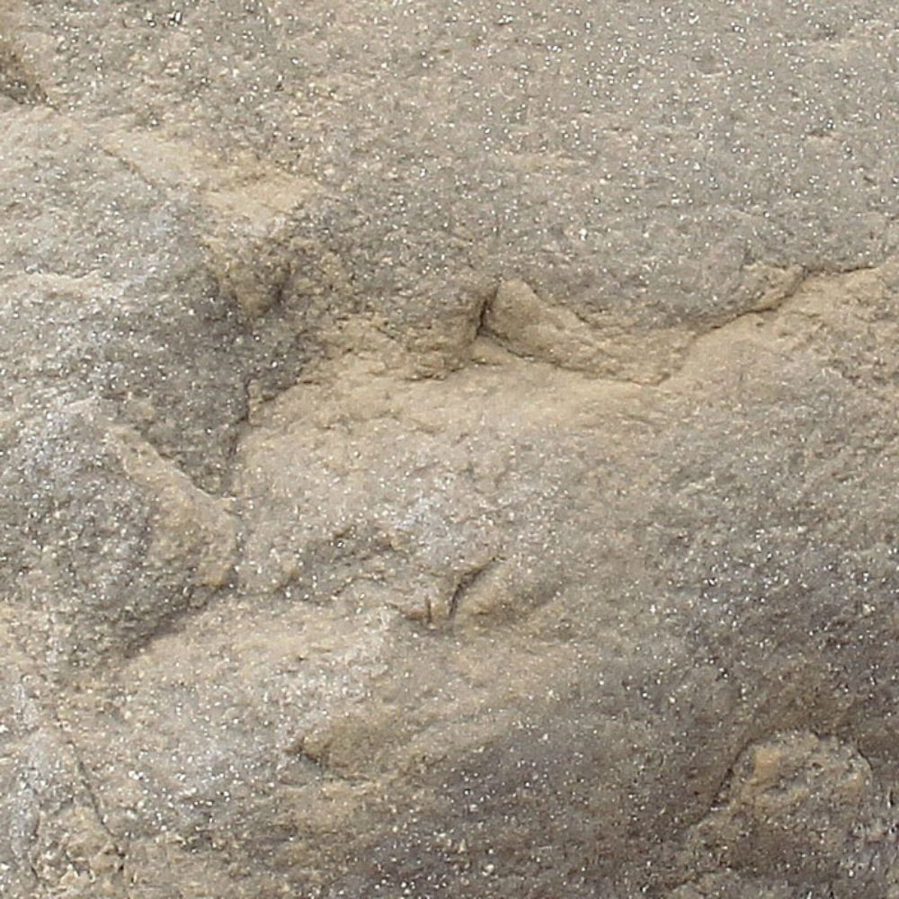 Close-up of DekoRRa’s Sandstone faux rock texture, a beige-colored surface designed for blending into natural landscapes and covering utilities.