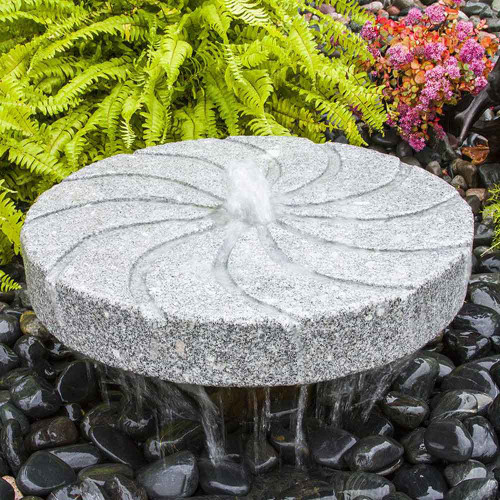 Blue Thumb Raised Swirl Millstone Fountain Shown With Black Pebble Option View Product Image