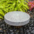 Blue Thumb Raised Angled Millstone Fountain Shown With Black Pebbles View Product Image