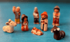 Close-up of Peruvian nativity figures wearing folk clothing, including striped ponchos, woven shawls, and classic Andean chullo hats. Close-up of Peruvian nativity figures wearing folk clothing, including striped ponchos, woven shawls, and classic Andean chullo hats.