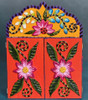 Exterior view of the closed Peruvian retablo, featuring bright floral designs hand-painted on the wooden doors.