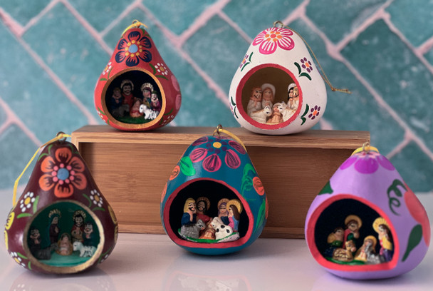 Fair Trade Peruvian gourd nativity ornaments featuring colorful hand-painted gourds with miniature clay manger scenes inside, handmade by artisans in Peru.