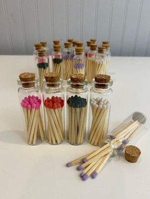 Matches in glass jar. Colors: white, black, lavender, pink and red.