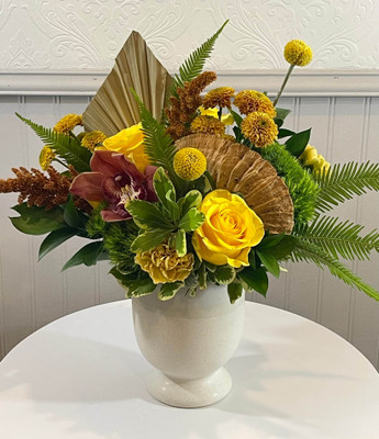 November Birth Month Floral
The gemstone for November is golden topaz or citrine. These tones include yellows and golden yellows with a bit of a coppery/bronze hue. We are combinine yellow roses, carnations, craspedia and mums together with bronze upright amaranth and cymbidium orchid bloom. The dried accents of spear palm and mushroom give it a boost towards an autumnal design. Finished with mixed foliage this is designed in a cream toned ceramic pot and varies in price. Super fun for a birthday in November or really just anyday for a burst of sunshine with flowers!
NOVEMBER:golden topaz or citrine, DECEMBER:Blue Zircon, Blue Topaz, or Tanzanite JANUARY:Garnet,  FEBRUARY:Amethyst, MARCH:Aquamarine, APRIL:Diamond, MAY:Emerald, JUNE:Alexandrite or Pearl, JULY:Ruby, AUGUST:Peridot or Spinel, SEPTEMBER:Sapphire, OCTOBER:Tourmaline or Opal
Designer Tip: pair this floral with Kundalini Candle and our boxed matches for a stylish look!
Seattle flower delivery by Juniper Flowers
Due to changes in season, weather, and availability we reserve the right to make substitutions in flowers for your order. Our photos are a GUIDE to our designs.