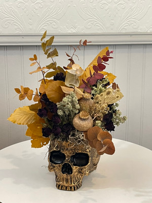 Image of Skull - Dried Floral "Autumn Breeze" Skull - Dried Floral "Autumn Breeze"
This everlasting holiday item is perfect for Halloween (or everyday if you just love skulls!) and will keep for years to come. This makes a great gift or decorative item for someone you know who likes the Noir vibe all year long. Flowers are dried and inserted into top of skull. You could reuse the skull at a later date with a small potted plant in top.
Seattle flower delivery by Juniper Flowers