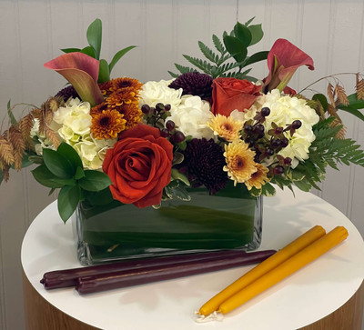 Autumn Centerpiece

Available in small, medium, and large sizes. Designed in our clear glass rectangle vase with green leaf inside to conceal flower stems. We'll use a variety of mums, roses, poms, callas, and other seasonal favorites in tones of orange, apricot, latte, gold, bronze. Complete the look with a pair of taper candles to complement the centerpiece - choose from mustard or plum color candles, or opt out.

Seattle flower delivery by Juniper Flowers

Due to changes in season, weather, and availability we reserve the right to make substitutions in flowers for your order. Our photos are a GUIDE to our designs.