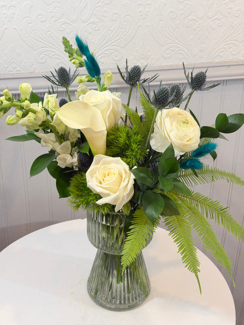 March Birth Month Floral

March's gemstone is Aquamarine. We portray that watery mix of blue and green with an aqua colored translucent vase, white calla, roses and snapdragons, blue thistle and a hint of wispy turquoise bunny tail tufts. A perfect start to Spring!

NOVEMBER:golden topaz or citrine, DECEMBER:Blue Zircon, Blue Topaz, or Tanzanite JANUARY:Garnet,  FEBRUARY:Amethyst, MARCH:Aquamarine, APRIL:Diamond, MAY:Emerald, JUNE:Alexandrite or Pearl, JULY:Ruby, AUGUST:Peridot or Spinel, SEPTEMBER:Sapphire, OCTOBER:Tourmaline or Opal

Designer Tip: pair this floral with Kundalini Candle and our boxed matches for a stylish look!

Seattle flower delivery by Juniper Flowers

Due to changes in season, weather, and availability we reserve the right to make substitutions in flowers for your order. Our photos are a GUIDE to our designs.