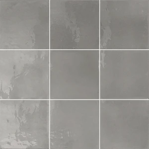 Typic reimagines traditional handcrafted ceramic wall tiles in a compact 100x100mm format. This glazed, gloss-finish wall tile has a gently uneven surface, so light pools and shifts across every piece. Mud leans into the range's grey side, a rich, slate tone that grounds a scheme and adds depth without tipping into anything too dark or heavy. A gloss wall tile for kitchens, bathrooms, hospitality spaces and feature walls, Typic Mud can be laid in a grid or brick-set pattern to play up its handmade character.