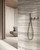 Astral Pearl Decor takes the same soft ivory, grey and taupe veining and adds a ribbed, three-dimensional matt texture across a 600x1200mm porcelain tile for a softer, more tactile finish overall. Raised linear ridges follow the tile's natural striations, catching light and shadow differently as you move past, adding real depth and texture that goes well beyond a flat surface alone. Best used as a feature wall in bathrooms, showers or entryways, this ribbed matt finish brings texture, softness and quiet visual interest to pale, neutral interior colour schemes.