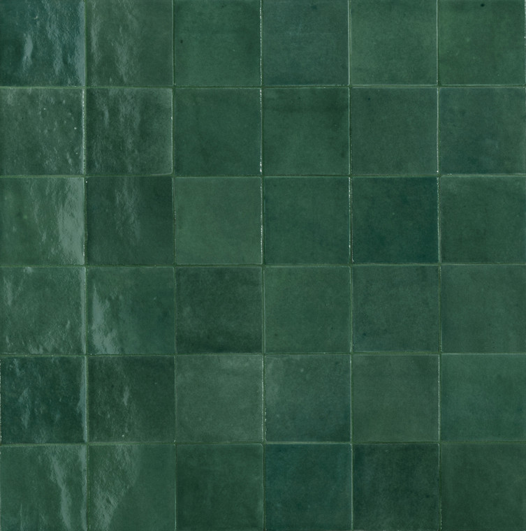 Melange Teal introduces a rich, green-toned colourway into the Melange range, bringing depth and character to spaces that call for something more distinctive than a standard neutral tile. Significant variation in texture, pattern and colour across each tile means the overall surface has real movement, with tones shifting subtly from piece to piece rather than repeating in a flat, uniform way. The 100x100mm format holds a broadly regular shape, while irregular edges add a soft, tactile texture that suits more artisan-inspired interiors. A glossy glaze sits over the surface, catching light and deepening the richness of the green tones for a vibrant, graphic result. It's a striking option for anyone after green feature wall tiles or bathroom tiles with genuine chromatic intensity, and at Tile Space we recommend it for New Zealand homes wanting to bring a warm, distinctive atmosphere into smaller, more personal spaces.