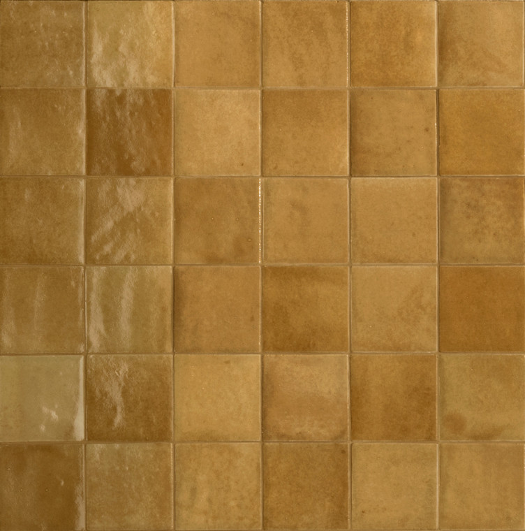 Melange Kaki brings an earthy, khaki-yellow tone into the Melange range, pairing warmth with genuine chromatic intensity. Significant variation in texture, pattern and colour across the tiles means walls built from this range feel layered and organic, with each piece contributing a slightly different note to the overall look. The 100x100mm format keeps things broadly regular in shape, while irregular edges add a tactile, handcrafted quality that suits more distinctive, characterful interiors. A glossy glaze finishes the surface, reflecting light and lifting the depth of the khaki tones for a warm, inviting result. It's a good fit for anyone looking for something different from standard neutral tiling — think warm-toned bathroom tiles or kitchen splashback tiles with real visual depth — and at Tile Space we find it works particularly well in New Zealand homes wanting an earthy, atmospheric feel in personal spaces like ensuites and feature walls.