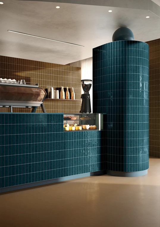 Amarcord Ottanio is a deep petrol teal, a moody blue-green with the kind of layered depth found in vintage glassware and old cinema interiors. The glossy glaze shifts between darker shadow and brighter highlight across the tile, lending every surface a subtle sense of texture and life. Ottanio suits kitchen splashbacks and feature walls where a rich, jewel-toned colour is the focal point of the room.