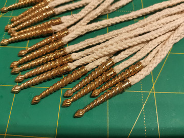 Hand-braided cord with brass tip
