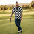 Man in checkered shirt and cap holding a golf club on a golf course