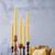 Pure Beeswax Taper Candles, Standard (12" x 7/8"), Natural – lit natural tapers in wooden holders