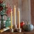 Pure Beeswax Taper Candles, Standard (12" x 7/8"), Natural – lit tapers with florals and a pumpkin