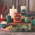 Holiday Aromatherapy Pillar Candle, Medium, Pine (Spruce & Fir) – lit holiday candles with greenery and cinnamon sticks