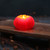 Beeswax Pumpkin Candle, Small 3" x 2" (Dark Orange) – lit small pumpkin in a dark room