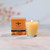 Beeswax Aromatherapy Beehive Glass Candle, Radiance – lit beehive glass candle by a window with its gift box