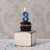 Beeswax Birthday Number Candle, 3 – lit on a frosted cupcake