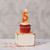 Beeswax Birthday Number Candle, 5 – lit on a frosted cupcake