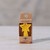 Beeswax Birthday Candle, Star – star candle package on a wooden table
