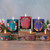 Winter Garden Beeswax Glass Candle, Clove Chamomile (6.2 oz) – lit Winter Garden glass candles and tins on a festive table