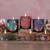 Winter Garden Beeswax Glass Candle, Clove Chamomile (6.2 oz) – lit Winter Garden glass candles and tins on a festive table