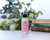 Aromatherapy Mist 4 oz, Love (Geranium, Lavender & Ylang Ylang) – on a sunny table with greenery and books