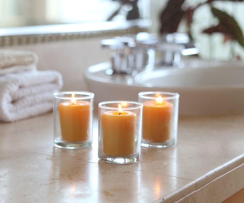 3 glowing beeswax votive candles