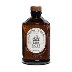 The first image features a front view of a brown glass bottle labeled "Brut Rose," which likely indicates a spirit infused with rose or having a rose-like flavor profile. The label showcases an elegant botanical illustration that may be representative of a rose. Above this illustration, the words "Eau de Vie" are printed, signifying the nature of the spirit as a distilled beverage. Below the image, the brand name "BACANHA" is prominently displayed.