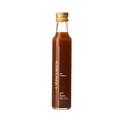 Fig vinegar in clear glass jar.