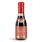 This image depicts a bottle of Giuseppe Giusti Aceto Balsamico di Modena, featuring a rich, dark color that suggests the contents are balsamic vinegar. The bottle is topped with a metallic red cap that complements the main label. A prominent feature on the neck is the Giusti family crest, a white cross on a red shield, which is a hallmark of the brand's legacy.

The main label has a vibrant red background that catches the eye, with gold and black text and detailing that adds to the luxurious feel of the product. The text "Aceto Balsamico Giuseppe Giusti Modena" is clearly visible, confirming the product as a traditional balsamic vinegar from Modena by the Giusti brand. Additional decorative motifs and script likely provide further information about the vinegar's characteristics and heritage.

The overall presentation of the bottle suggests a premium quality balsamic vinegar, suitable for enhancing the flavors of a wide range of culinary dishes.
