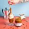 Coffee curd in clear glass jar with gold lid.