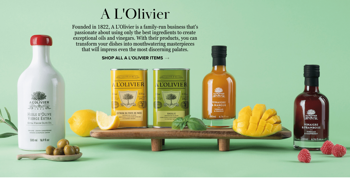 Colorful selection of L'Olivier olive oils and vinegars, featuring extra virgin olive oil, lemon olive oil, basil olive oil, mango vinegar, and raspberry vinegar, presented in glass bottles and jars on a serene light green/blue backdrop.