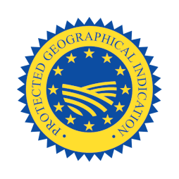  The image features a circular seal or logo with a royal blue background and a golden-yellow border. Inside the border, there is a repeating text that reads "INDICAZIONE GEOGRAFICA PROTETTA" which translates to "Protected Geographical Indication" in English. This label is commonly used in European Union countries to designate products with qualities or a reputation that are due to that specific geographic origin.  In the center of the seal, there's a golden-yellow stylized sheaf of wheat that radiates outwards, with the tips pointing towards the edges of the seal. The sheaf forms a semi-circle and is overlaid by a band that carries the same golden-yellow color as the border and the wheat. Across the band, there's a row of 12 five-pointed stars arranged in a circle, which is reminiscent of the flag of the European Union.  This emblem is likely used to certify that a food or agricultural product is of a certain quality and produced within a designated geographical area, according to specific regulations.