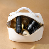 Night Balm Rich Multi-Youth Cream and Hydra Volume Lip Plumping Serum laying together in a white pouch.