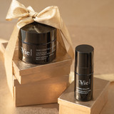 Time Control Deep Wrinkle Firming Rich Cream and the Hydra Volume Lip Plumping Serum, sitting on gift boxes with a bow tied around them.