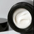 Mela Bright Dark Spot Brightening Cream jar with opened lid.