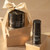 Time Control Deep Wrinkle Firming Rich Cream and the Hydra Volume Lip Plumping Serum, sitting on gift boxes with a bow tied around them.