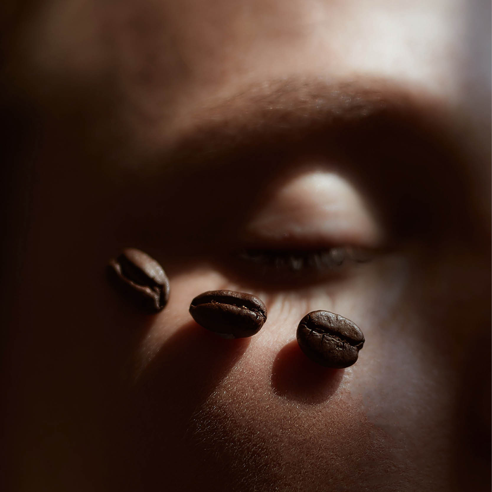 Women's Eye Contour with Coffee Beans on her skin.