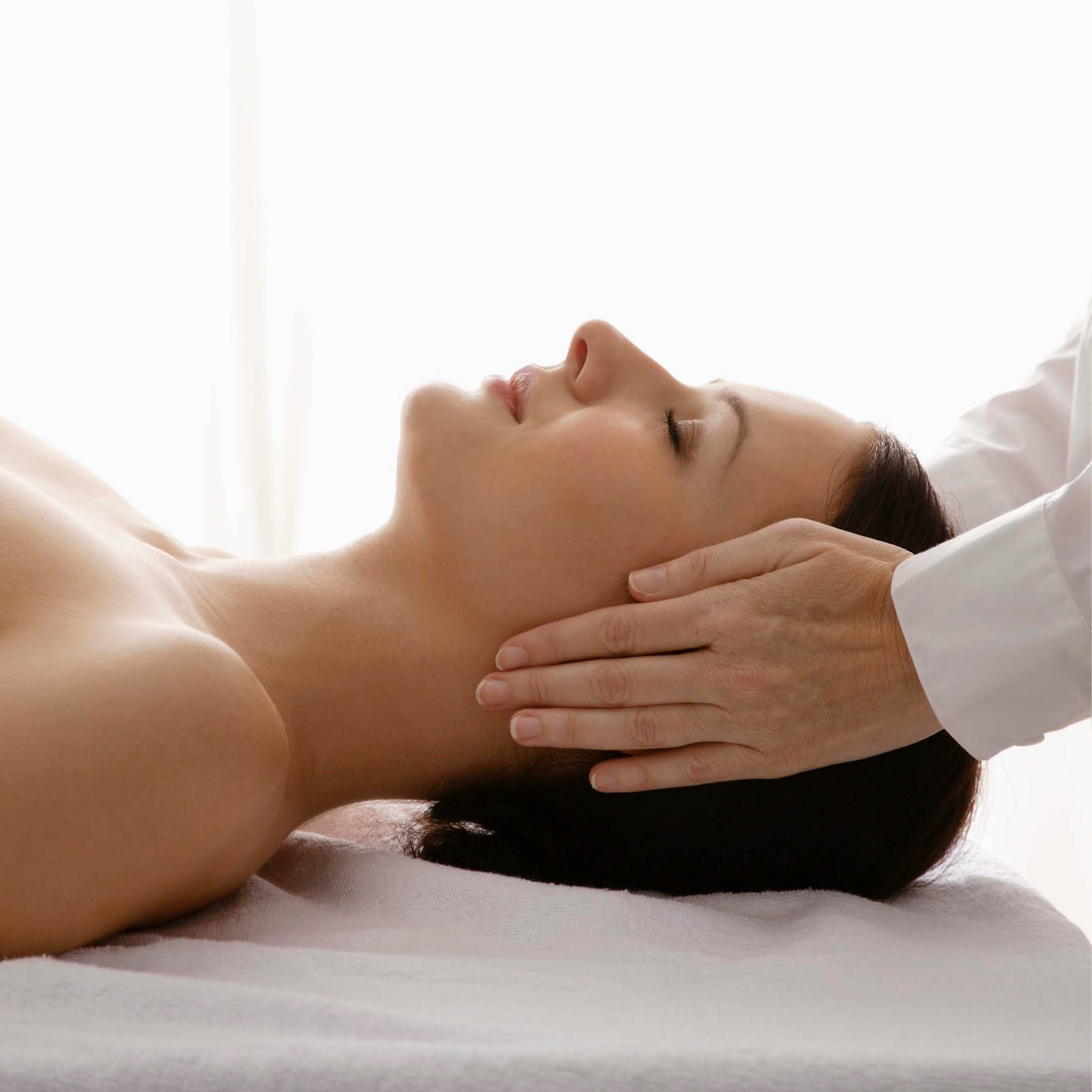 Woman receiving a facial spa treatment