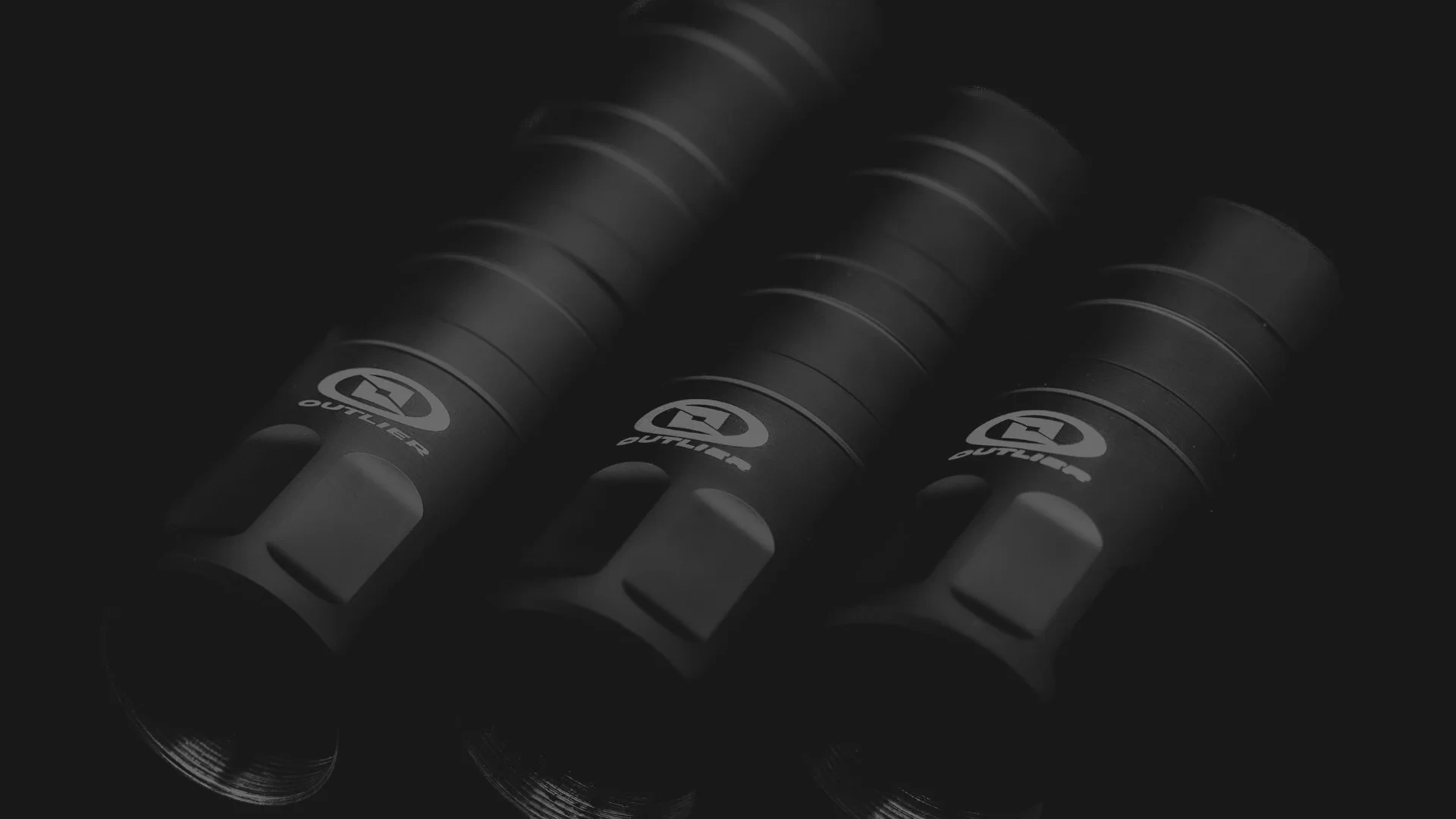 Three black flashlights with logos on a dark background.