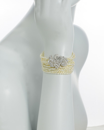 Hyoko Pearl bracelet on model, 12 strands of luxe seeds pearls individually hand-knotted on silk with a Sterling Silver center-set Swan pair, hand-set with multi-size pavé CZ’s, and a Sterling Silver clasp. Hyoko Pearl bracelet on model, 12 strands of luxe seeds pearls individually hand-knotted on silk with a Sterling Silver center-set Swan pair, hand-set with multi-size pavé CZ’s, and a Sterling Silver clasp.