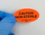 Lab technician applying CAUTION NON-STERILE Caution Label in medical device manufacturing facility