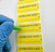 Lab manager writing on C094 EXPIRATION DATE Caution Label