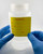 SAMPLE Material Label being applied to lab container with containing chemical samples