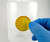 M032 MATERIAL CONTROL Material Label being applied to solvent bottle by lab technician