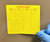 Inventory manager applying INVENTORY material label to storage shelf