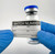 Lab technician applying Batch Number Label to vial to match with entire test batch